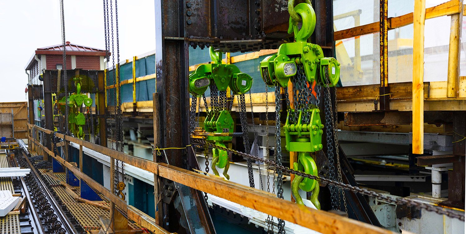 LGH hand chain hoists, lifting a section of track for the train system in New york city.